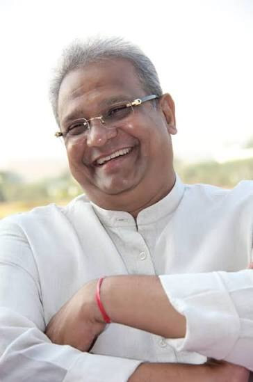 Bhupesh R. Patel photographed outdoors in a white kurta, arms folded